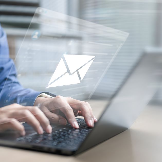 Symbol: Man writing an email on his laptop