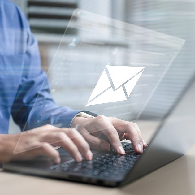 Symbol: Man writing an email on his laptop
